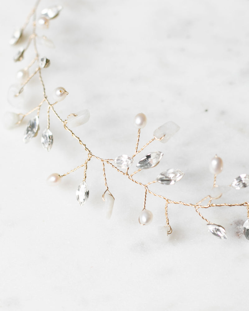 Close flatlay details of the Moonflower Bridal Hair Vine in gold, with moonstone, pearls, and crystals.