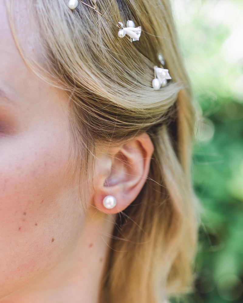 A close model view of the Pearl Stud Earrings in classic 8mm.
