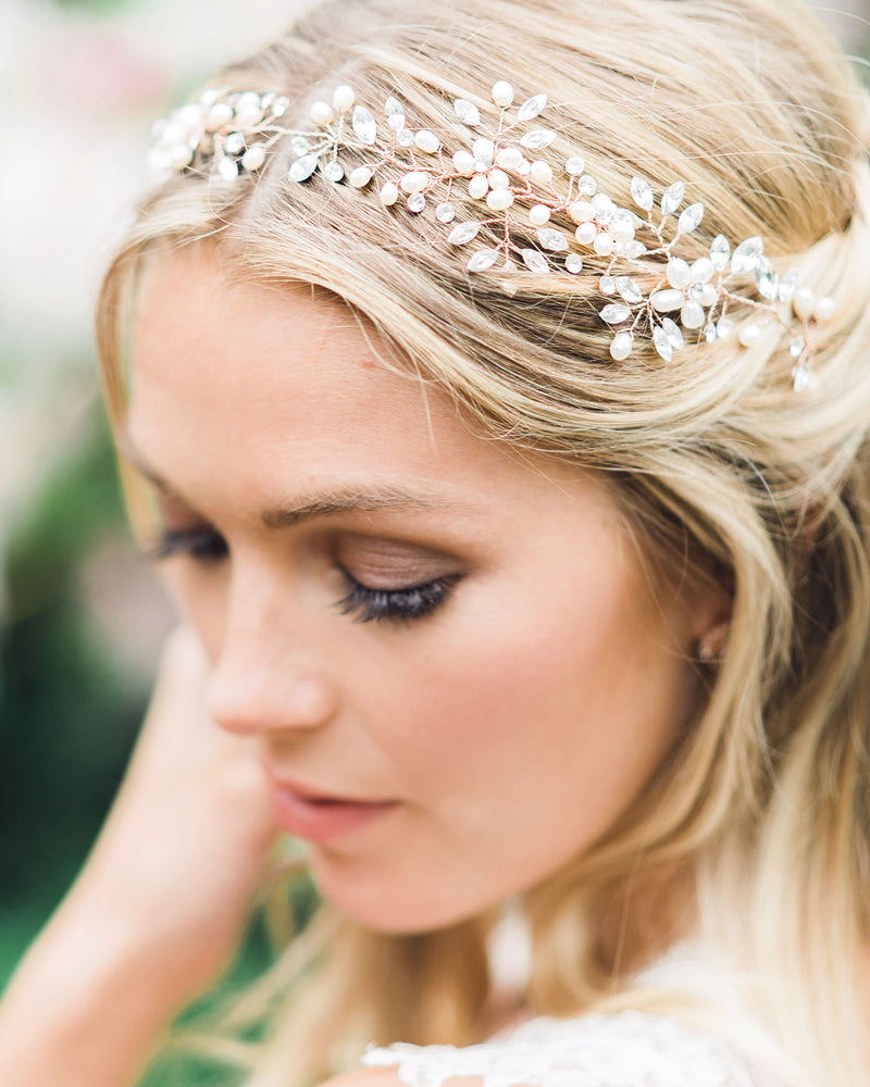 A close view on model of the Reverie Bridal Halo in rose gold, with pearls and scattered crystals.