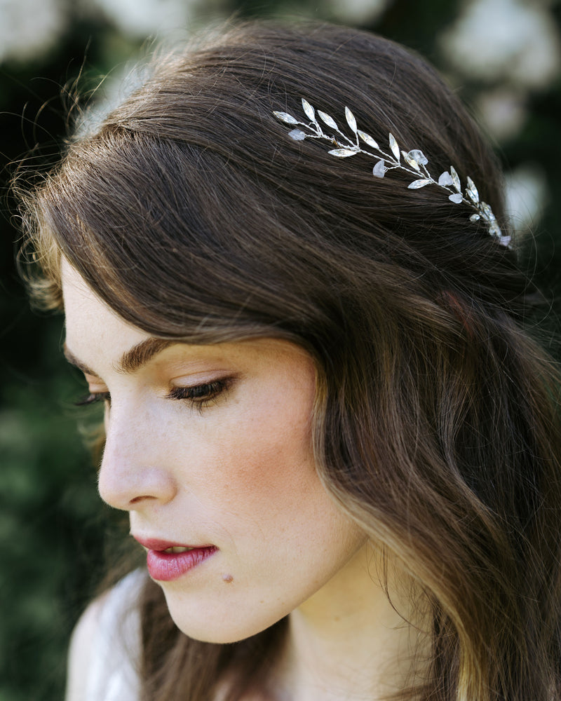 A bride wears the Sea Mist Bridal Hair Comb in silver with rose quartz gemstones.