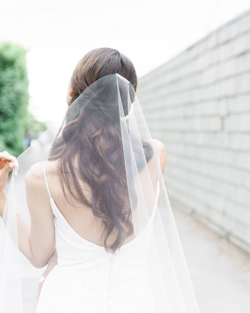Close model view of the comb and hand-cut edge on the Senna Lace Veil.