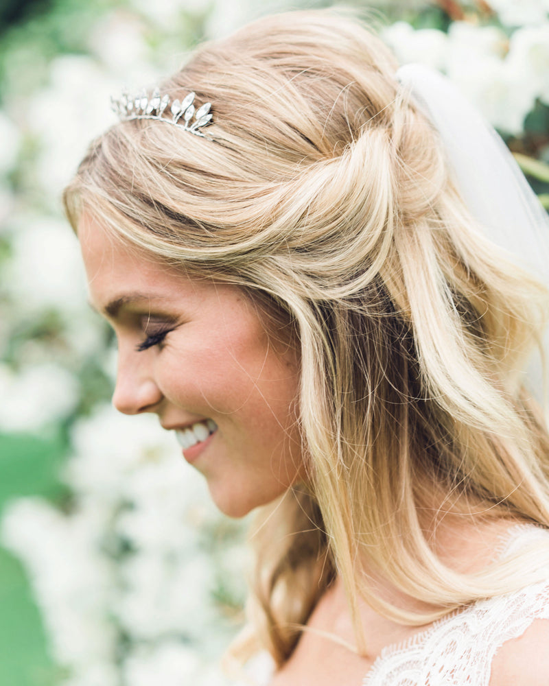 A bride wears a delicate crown made of sparkling crystals.