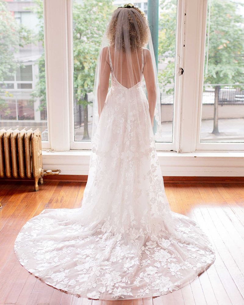 A back view of a bride wearing the Wildflower Floral Lace Veil.